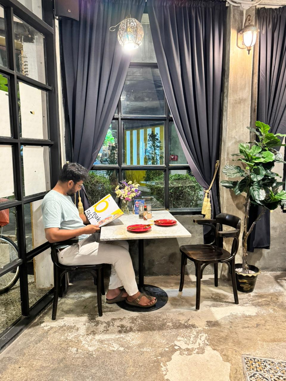 Kushal thoroughly reading a menu